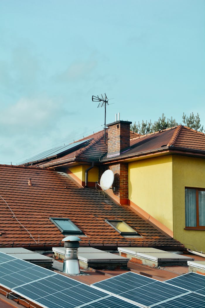 about-us-02 Yellow building with solar panels and antennas on rooftop in Poland. Eco-friendly technology.